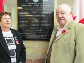 Elaine and Errol Cushley, the parents of William Jonathan James Cushley who died in action in 2006 while serving with the Canadian army in Afghanistan, stand next to a memorial plaque following its dedication on Thursday November 10, 2016 at St. Patrick's Catholic High School in Sarnia, Ont. William Cushley's name is listed on the memorial along with 29 other students from Sarnia Catholic parishes who died while serving in the military in conflicts from the First World War to the mission in Afghanistan. (Paul Morden/Sarnia Observer)