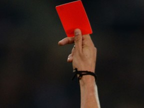 A referee flashes a red card. (AFP)