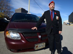 Veteran John Collins parked in the Impark parking lot at York and Clarence streets to attend a Veterans Appreciation event at a London Knights game at Budweiser Gardens and was shocked to see he had a parking ticket. Impart had been granting free parking to veterans with a poppy licence plate but has recently changed their policy. Photo taken on Thursday Nov 10, 2016. (MORRIS LAMONT, The London Free Press)