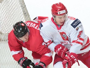 Sudbury Wolves forward Alan Lyszczarczyk (right) competes for the Polish national team in an exhibition game against Lithuania this past spring. Lyszczarczyk hopes  to win gold next month with the Polish junior team. PZHL Photo