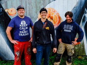 Local artist Stefan Duerst is flanked by visiting German graffiti artists Bert (Nils Janisch) and Loomit (Mathias Kohler) at Duerst’s home in Godfrey in October. Duerst and Loomit collaborated on a project titled “Fluid Forms,” which opens this week in Kingston. (Photo courtesy of Andrew McLachlan)