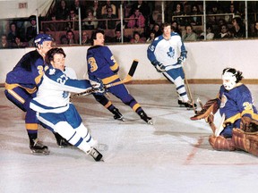 Toronto Maple Leafs forward Darryl Sittler takes on Los Angeles Kings goalie Rogie Vachon.