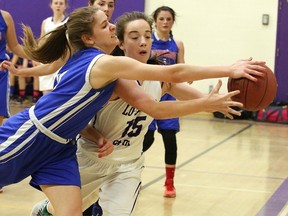Lo-Ellen's Kate Dahmer (right) gets tangled with a Macdonald Cartier player during Division I senior girls semifinal action at Lo-Ellen on Wednesday night. The Knights will meet the Lockerby Vikings in Saturday's city final. Gino Donato/The Sudbury Star