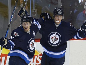 Winnipeg Jets right winger Patrik Laine (right) celebrates his first period goal against the Dallas Stars with centre Mark Scheifele on Tuesday night. The pair lead the Jets into Denver on Friday for a game with the Colorado Avalanche. (Brian Donogh/Winnipeg Sun)