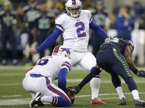 Seattle Seahawks cornerback Richard Sherman, right, reaches out to grab the ball on a failed field goal attempt by Buffalo Bills kicker Dan Carpenter (2) as Colton Schmidt holds in the first half of an NFL football game, Monday, Nov. 7, 2016, in Seattle. Sherman was given a defensive offsides penalty on the play. (AP Photo/John Froschauer)