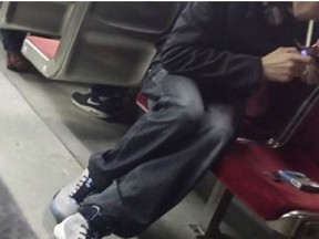 A man smokes what he claimed was fentanyl in a photo taken by another passenger on a St. Clair streetcar. (Twitter)