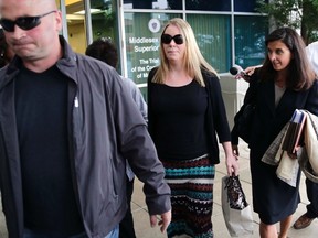 Aisling Brady McCarthy, center, leaves court with her attorney, Melinda Thompson, right, following a status hearing at Middlesex Superior Court in Woburn, Mass., Tuesday, May 19, 2015. McCarthy, a nanny from Ireland, is accused of killing a 1-year-old Massachusetts girl in her care two years ago. (AP Photo/Charles Krupa)