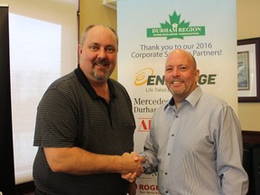 Doug Tarry, left, is thanked by DRHBA President Ken Russell for sharing his knowledge at a DRHBA breakfast workshop on the new Ontario Building Code.