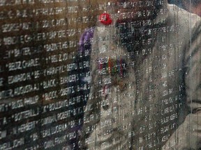 A wreath-laying ceremony to mark the 71st anniversary of the Battle of Hong Kong in 2012. The ceremony took place at the "C" Force Memorial Wall in Ottawa. Hong Kong veteran Dempsey Syvret of the Royal Rifles took part int he ceremony. Syvret is reflected in the Memorial Wall. FILE PHOTO