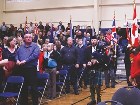 Members of the Vulcan Legion following the bag pipe player and carried the flags during the Remembrance Day Service at the Cultural-Recreational Centre.