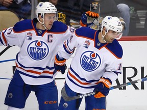 Edmonton Oilers Jordan Eberle, right, celebrates his goal with teammate Connor McDavid during the first period of an NHL hockey game against the Pittsburgh Penguins in Pittsburgh, Tuesday, Nov. 8, 2016.