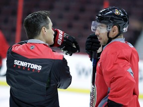 Senators coach Guy Boucher (left) and forward Chris Kelly. (Darren Brown, Postmedia Network)