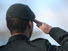 An individual salutes during the playing of the Last Post at the Remembrance Day service, in Vimy Ridge Memorial Park, in Winnipeg. Friday, November 11, 2016. (Sun/Postmedia Network)