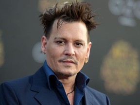 FILE - In this May 23, 2016 file photo, Johnny Depp arrives at the premiere of "Alice Through the Looking Glass" at the El Capitan Theatre, in Los Angeles. Depp is about to enter a world of magic. The actor is set to be part of "Harry Potter" author J.K. Rowling's "Fantastic Beasts and Where to Find Them" universe in a secretive role, according to a Warner Bros. representative Tuesday, Nov. 1, 2016. (Photo by Richard Shotwell/Invision/AP, File)