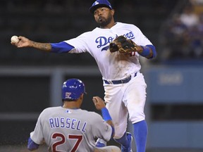 In this Oct. 20, 2016, file photo, Chicago Cubs' Addison Russell is out at second as Los Angeles Dodgers' Howie Kendrick turns a double play on a ball hit by Albert Almora Jr. during the ninth inning of Game 5 of the National League baseball championship series in Los Angeles. The Phillies on Friday, Nov. 11, acquired Kendrick from the Los Angeles Dodgers for Darin Ruf and utilityman Darnell Sweeney. (AP Photo/Mark J. Terrill, File)