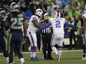 Buffalo Bills kicker Dan Carpenter complains to referee Walt Anderson late in the first half of an NFL football game against the Seattle Seahawks, in Seattle. Richard Sherman spent last week criticizing what he believed were incorrect calls, only to be at the center of another officiating flap Monday night that this time went Seattle's way. (AP Photo/John Froschauer, File)
