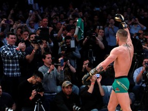 UFC featherweight champion Conor McGregor motions to the crowd during UFC 205 Open Workouts at Madison Square Garden on Nov. 9, 2016 in New York City. (Michael Reaves/Getty Images)