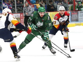 David Levin, middle, of the Sudbury Wolves, slips between Ryan Martin, left, and Brett Neumann, of the Erie Otters, during OHL action at the Sudbury Community Arena in Sudbury, Ont. on Friday November 11, 2016. John Lappa/Sudbury Star/Postmedia Network