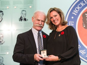 Kalli Quinn receives her father Pat Quinn's Hockey Hall of Fame ring from Lanny McDonald on Friday. (Craig Robertson/Toronto Sun)