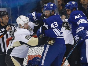 Sidney Crosby of the Pittsburgh Penguins (left) and Nazem Kadri of the Toronto Maple Leafs mix it up during an NHL game on Nov. 14, 2014. (CRAIG ROBERTSON/Toronto Sun files)