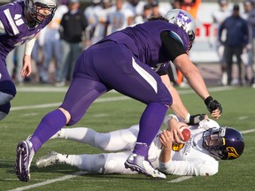 Western Mustangs defensive tackle Rupert Butcher sacks Laurier Golden Hawks quarterback Eric Morelli during their OUA semifinal playoff football game at TD Stadium in London, Ont. on Saturday, November 7, 2015. Western beat Laurier 32-18. (Free Press file photo)