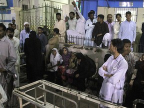 People gather outside an emergency ward of a local hospital after hearing news of a bomb blast at a Sufi shrine, in Karachi, Pakistan, Saturday, Nov. 12, 2016. (AP Photo/Fareed Khan)