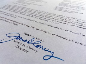 Part of a Nov. 6, 2016, letter from FBI director James Comey to Congress is photographed in Washington, Sunday, Nov. 6, 2016. Comey tells Congress that a review of new Hillary Clinton emails has "not changed our conclusions" from earlier this year that she should not face charges. (AP Photo/Jon Elswick)