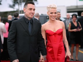 Off-road truck racer Carey Hart and singer Pink attend the 56th GRAMMY Awards at Staples Center on January 26, 2014 in Los Angeles, California.  (Photo by Christopher Polk/Getty Images for NARAS)