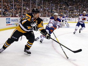 Pittsburgh Penguins' Sidney Crosby gets off a pass in front of Edmonton Oilers' Connor McDavid during the second period of an NHL hockey game in Pittsburgh, Tuesday, Nov. 8, 2016. (AP Photo/Gene J. Puskar)
