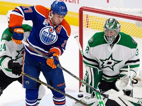 The Edmonton Oilers' Milan Lucic (27) tries to deflect a shot past the Dallas Stars' goalie Kari Lehtonen (32) during first period NHL action at Rogers Place, in Edmonton on Friday Nov. 10, 2016.
