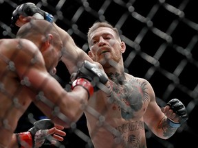 Conor McGregor of Ireland punches Eddie Alvarez in their UFC lightweight championship fight in their UFC lightweight championship fight during the UFC 205 event at Madison Square Garden on Nov. 12, 2016 in New York City.  (Michael Reaves/Getty Images)