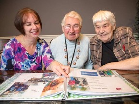 Annie Herweyer, centre, looks through a photo album with her daughter, Marianne Sabourin, left, and friend Betty Hay. Herweyer lived out her dream of returning to Holland to visit her brother.