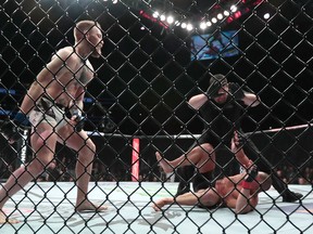 Conor McGregor reacts after the referee stopped his lightweight title mixed martial arts bout against Eddie Alvarez at UFC 205 on Nov. 12, 2016 at Madison Square Garden in New York. (AP Photo/Julio Cortez)