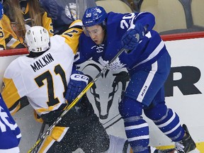 Toronto Maple Leafs' Frank Corrado checks Pittsburgh Penguins' Evgeni Malkin along the boards in the first period of an NHL hockey game in Pittsburgh on Nov. 12, 2016. (AP Photo/Gene J. Puskar)