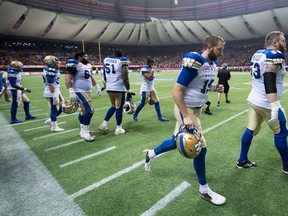 Winnipeg Blue Bombers quarterback Matt Nichols, second right, and Patrick Neufeld, right, leave the field after losing to the B.C. Lions during the CFL western semifinal playoff football game in Vancouver, B.C., on Sunday November 13, 2016. THE CANADIAN PRESS/Darryl Dyck