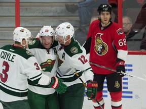 Ottawa Senators left winger Mike Hoffman looks on as Minnesota Wild defenceman Ryan Suter celebrates his goal during first period NHL action on Nov. 13, 2016 in Ottawa. (THE CANADIAN PRESS/Adrian Wyld)