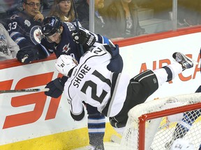 Los Angeles Kings center Nick Shore is dumped by Winnipeg Jets defenceman Jacob Trouba during NHL hockey in Winnipeg, Man. Sunday November 13, 2016.
Brian Donogh/Winnipeg Sun/Postmedia Network