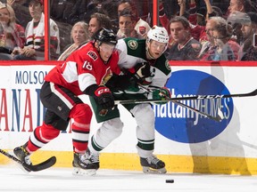 Senators forward Ryan Dzingel races Mikko Koivu of the Minnesota Wild for the puck at the Canadian Tire Centre. (Getty Images)