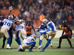 Winnipeg Blue Bombers' Justin Medlock, right, misses on a 61-yard field goal attempt as Weston Dressler holds during second half western semifinal CFL football action against the B.C. Lions in Vancouver, B.C., on Sunday November 13, 2016. THE CANADIAN PRESS/Darryl Dyck