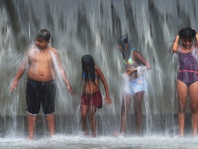Young people cool off beneath a water fountain in Madureira Park on December 30, 2015 in Rio de Janeiro, Brazil. The World Meteorological Organization says 2016 is set to break the record for the hottest year since measurements began in the 19th century. (Mario Tama/Getty Images)