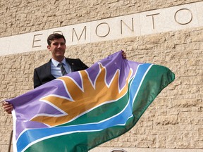 Mayor Don Iveson shows a new Edmonton flag he was given during Treaty Recognition Day outside of City Hall in Edmonton, Alberta on Thursday, September 22, 2016. Ian Kucerak / Postmedia