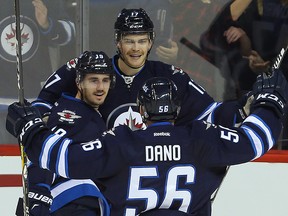 Winnipeg Jets centre Adam Lowry (centre) celebrates his first period goal against the Los Angeles Kings with AHL callups Nic Petan (left) and Marko Dano on Sunday against Los Angeles. (Brian Donogh/Winnipeg Sun)
