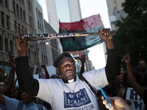 Ernest Walker – seen here holding a bat reading 'Black Power' during a protest in Dallas, Texas, on Thursday, July 7, 2016 – claims he had a free Veteran Day's meal taken away from him at Chili's. He said the ordeal has left him embarassed and dehumanized. (LAURA BUCKMAN/AFP/Getty Images)