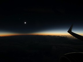 This photo provided by Dan McGlaun shows the full shadow of the moon during the total solar eclipse on Tuesday, March 8, 2016, as seen from an airplane over the North Pacific Ocean. So-called eclipse chasers boarded a special flight from Anchorage to Honolulu to view the eclipse on Tuesday from the air. (Dan McGlaun/eclipse2017.org via AP)