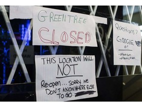 The Green Tree dispensary on Bank Street was one of six raided by Ottawa police, and according to this sign posted on the window, it won’t reopen. ERROL MCGIHON / POSTMEDIA
