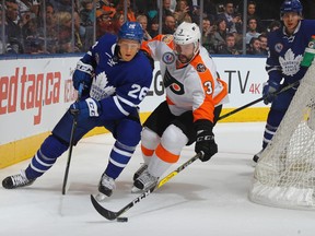 Philadelphia Flyers defenceman Radko Gudas (right) pokes the puck from Toronto Maple Leafs winger Nikita Soshnikov on Nov. 11. (Bruce Bennett/Getty Images)
