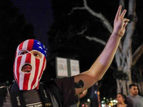 A demonstrator gestures during a protest against US President-elect Donald Trump in Los Angeles, California, on November 13, 2016. (RINGO CHIU/AFP/Getty Images)
