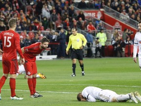 Toronto FC’s Drew Moor taunts Philadelphia’s Fabian Herbers during a game last month. Moor, Eriq Zavaleta (left) and Nick Nagglund have formed a fearsome trio. (THE CANADIAN PRESS)