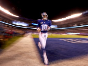 Eli Manning of the New York Giants runs off the field after warm-ups prior to the game against the Cincinnati Bengals at MetLife Stadium on Nov. 14, 2016 in East Rutherford, New Jersey. (Al Bello/Getty Images)
