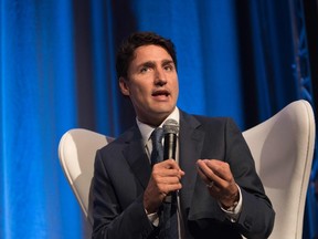 This file photo taken on October 13, 2016 shows Canadian Prime Minister Justin Trudeau speaks to business leaders on the free trade agreement between Canada and Europe in Montreal, Quebec. Canada's Prime Minister Justin Trudeau heads to Cuba November 15, 2016 as the breakthrough in US relations with the communist regime hangs in the balance following Donald Trump's presidential election win. The prime minister's official visit comes 40 years after his father Pierre Elliott Trudeau committed to a lifelong friendship with Fidel Castro during a three-day trip to the Caribbean island. (ALICE CHICHE/AFP/Getty Images)